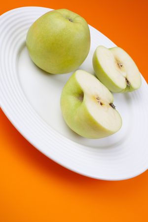 sliced green apple on white plateの写真素材
