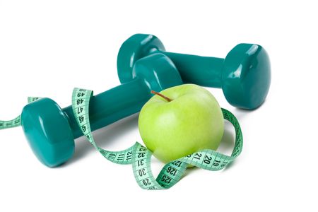green dumbell with measuring tape and green appleの写真素材