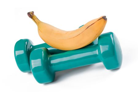 the green dumbell and yellow banana on white backgroundの写真素材