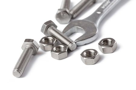chrome spanner with nuts and bolts on white backgroundの写真素材