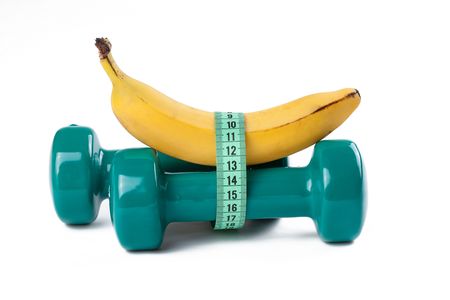 the green dumbell and yellow banana on white backgroundの写真素材