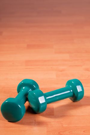 the green dumbells on wooden backgroundの写真素材