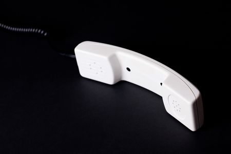 phone receiver on black backgroundの写真素材