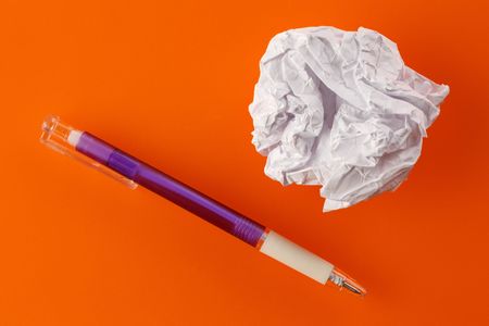 photo shot of paper ball and pen on color backgroundの写真素材