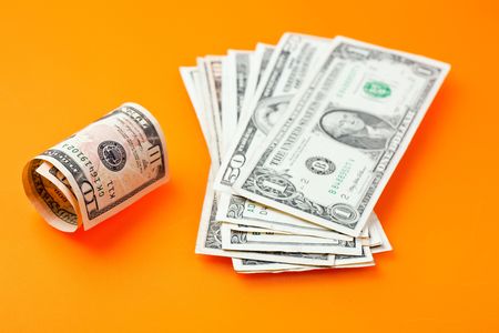 the photo shot of dollars on color backgroundの写真素材