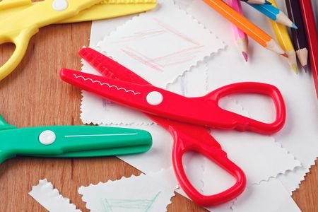 colourful scissors and crayons on tableの写真素材