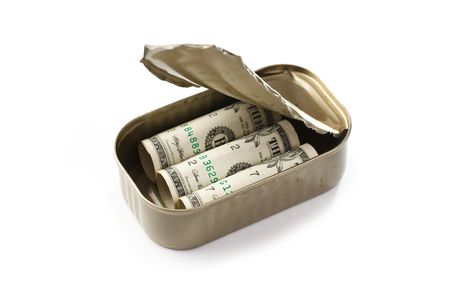dollars in sardines can on white backgroundの写真素材