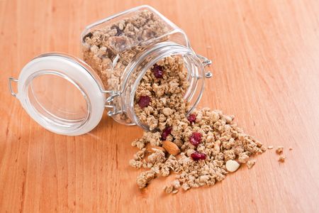 muesli in glass jar on wooden backgroundの写真素材