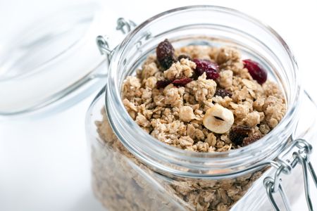 muesli in glass jar on white backgroundの写真素材