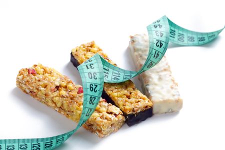 muesli bars with measuring tape on white backgroundの写真素材