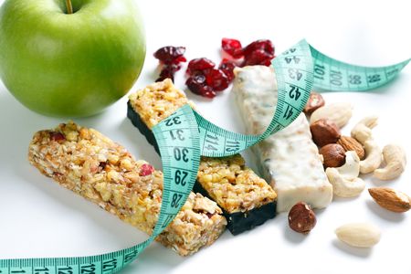 muesli bars with measuring tape on white backgroundの写真素材