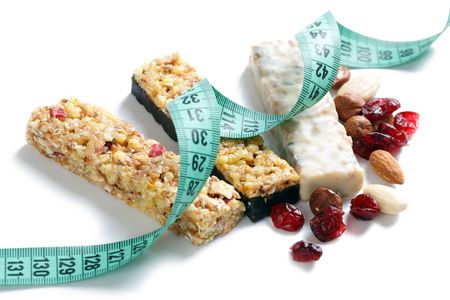 muesli bars with measuring tape on white backgroundの写真素材