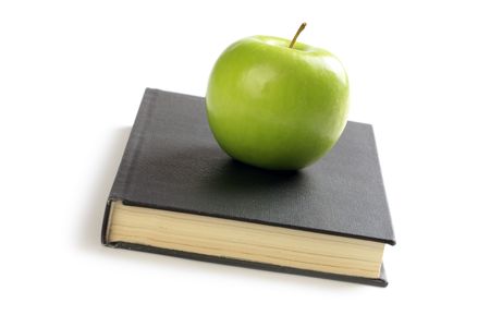 photo shot of green apple on bookの写真素材
