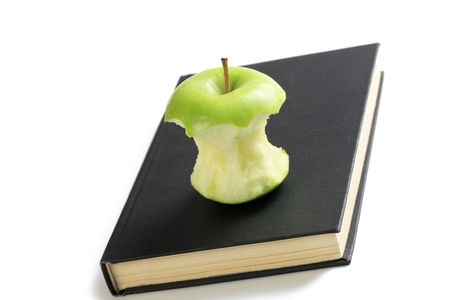 photo shot of bitten apple on bookの写真素材