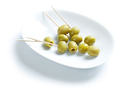 photo shot of green olives and toothpickの写真素材