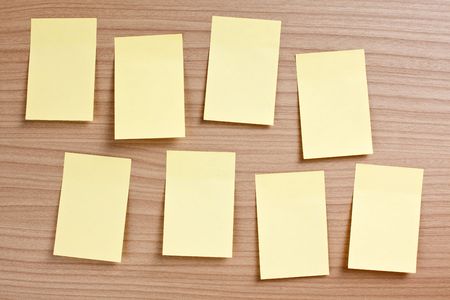 yellow note paper on wooden backgroundの写真素材