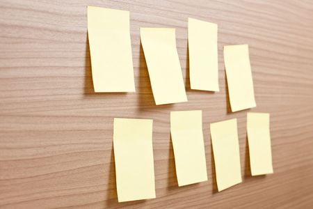 yellow note paper on wooden backgroundの写真素材