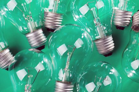 photo shot of light bulb on green backgroundの写真素材