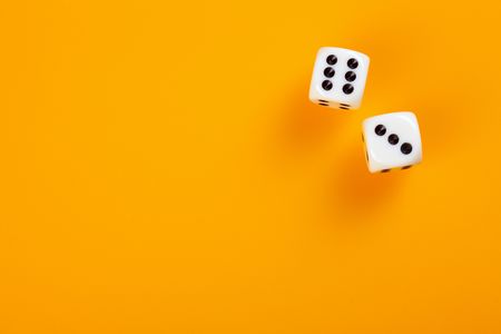 two dice on orange backgroundの写真素材