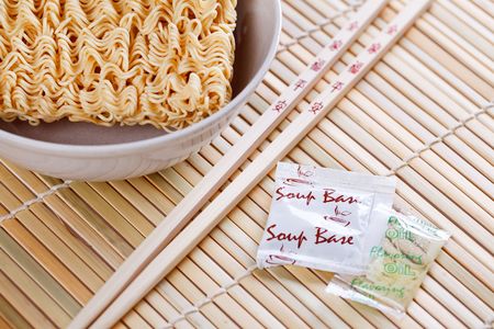 dried chinese noodles and chopsticks on tableの写真素材