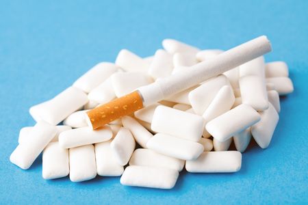 chewing gums and cigarette on blue backgroundの写真素材