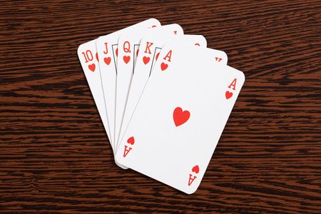 the poker cards on wooden tableの写真素材
