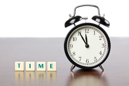 alarm clock and Scrabble words on table