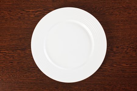 plate on a wooden tableの写真素材