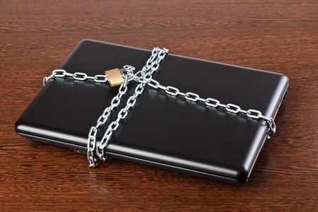 secured laptop on wooden backgroundの写真素材