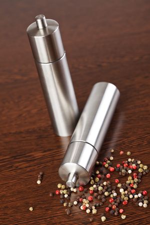 pepper mill on wooden tableの写真素材
