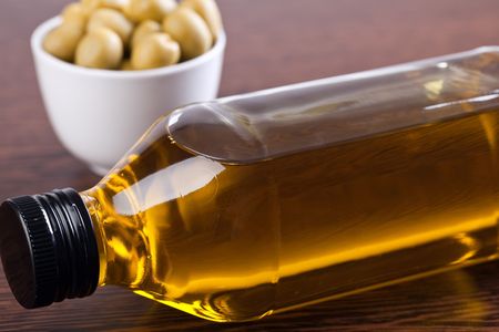 olives and olive oil on wooden tableの写真素材