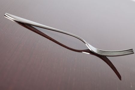 the silver fork on wooden tableの写真素材