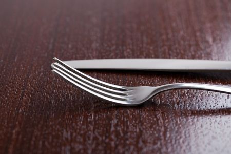 photo shot of cutlery on wooden tableの写真素材