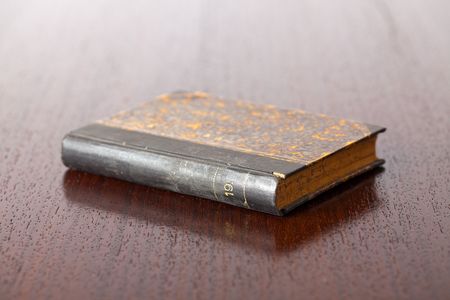 the old book on wooden tableの写真素材