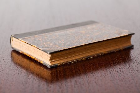 the old book on wooden tableの写真素材