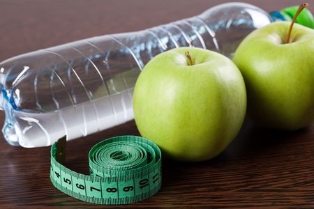 diet . photo shot of apple , water and measuring tapeの写真素材