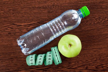 diet . photo shot of apple , water and measuring tapeの写真素材