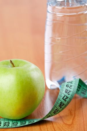 diet . photo shot of apple , water and measuring tapeの写真素材