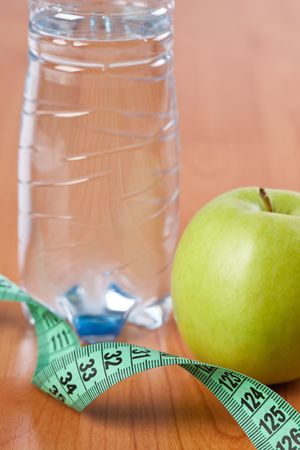 diet . photo shot of apple , water and measuring tapeの写真素材