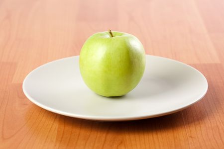 photo shot of green apple on plateの写真素材