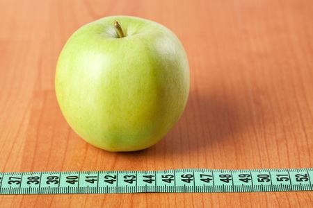 green apple and measuring tapeの写真素材