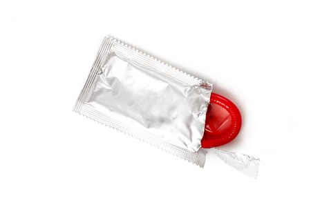 red condom on white backgroundの写真素材