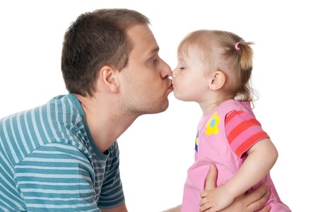 studio shot of little girl and her dad giving kissの写真素材