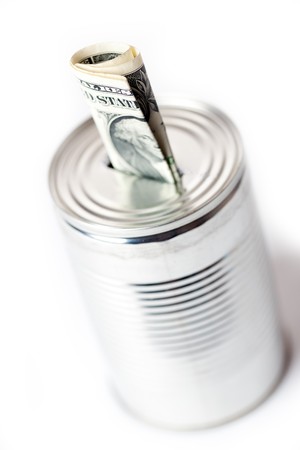 photo shot of paper currency in tin canの写真素材