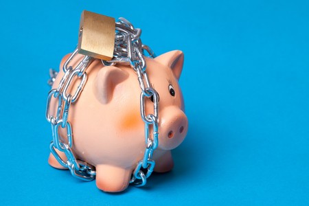 security your investment . piggy with chains and padlockの写真素材