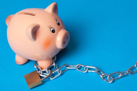 security your investment . piggy with chains and padlockの写真素材