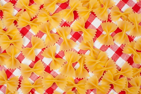 farfalle pasta on picnic tableclothの写真素材