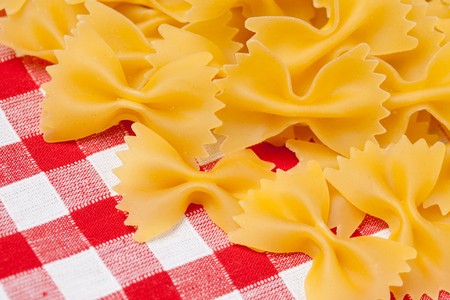 farfalle pasta on picnic tableclothの写真素材