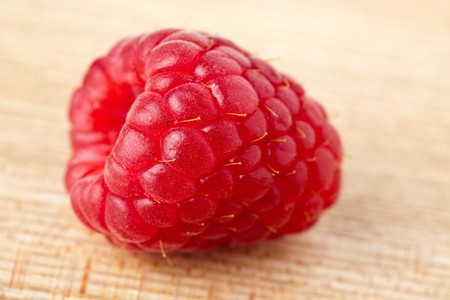 red raspberry on wooden table