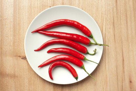 red chili peppers on woodden table